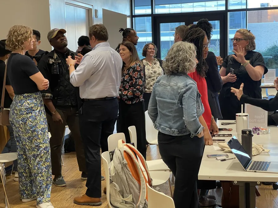 A Labs evening at the library: people talking in small groups around the tables.